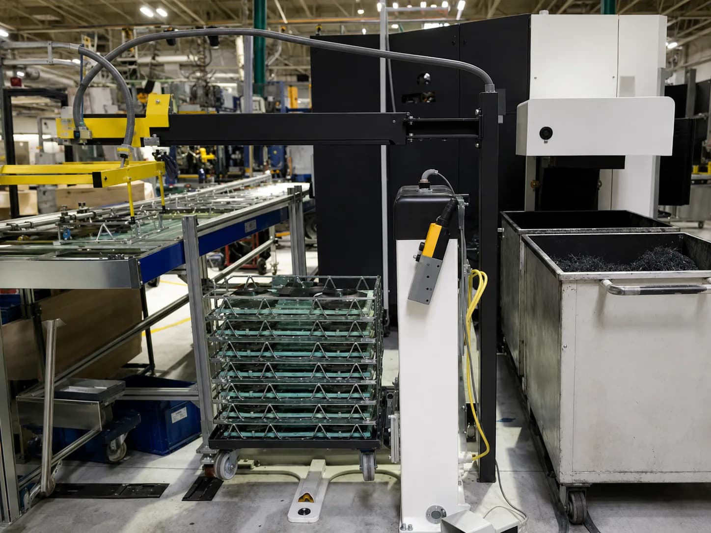 Vertical pallet lift integrated with production equipment and a material-transfer workstation